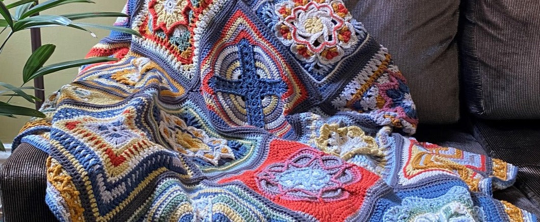 Deb's finished Nuts about Squares blanket draped on the couch