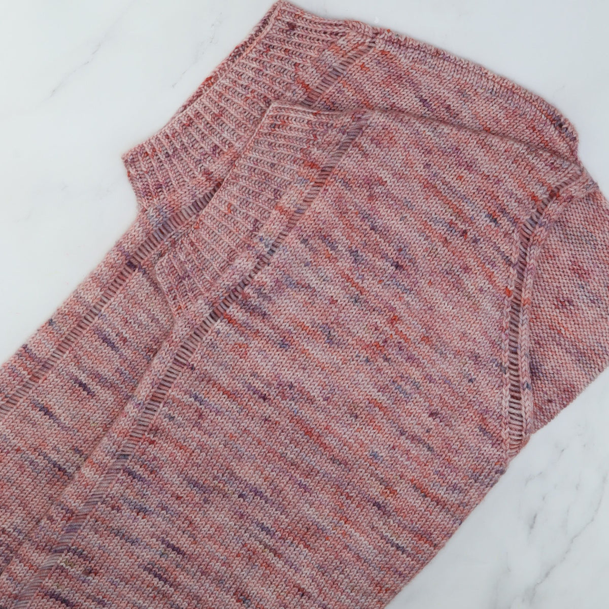 Outline Tee laid flat, showing the dropped-stitch edges and twisted rib, in Skein Sisters Fabulous Sock
