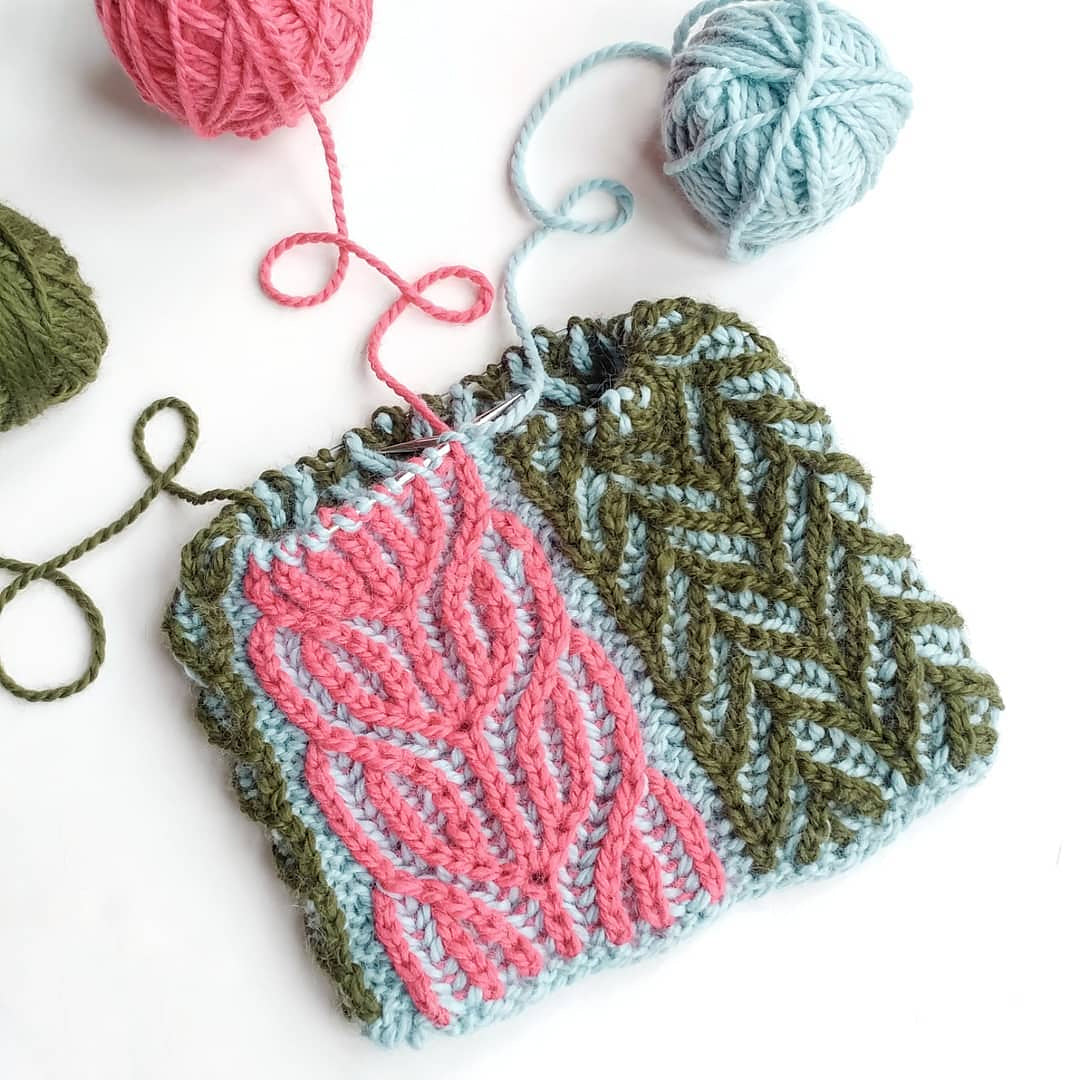 Colour-blocked brioche swatch in pink, green and pale blue with yarn balls