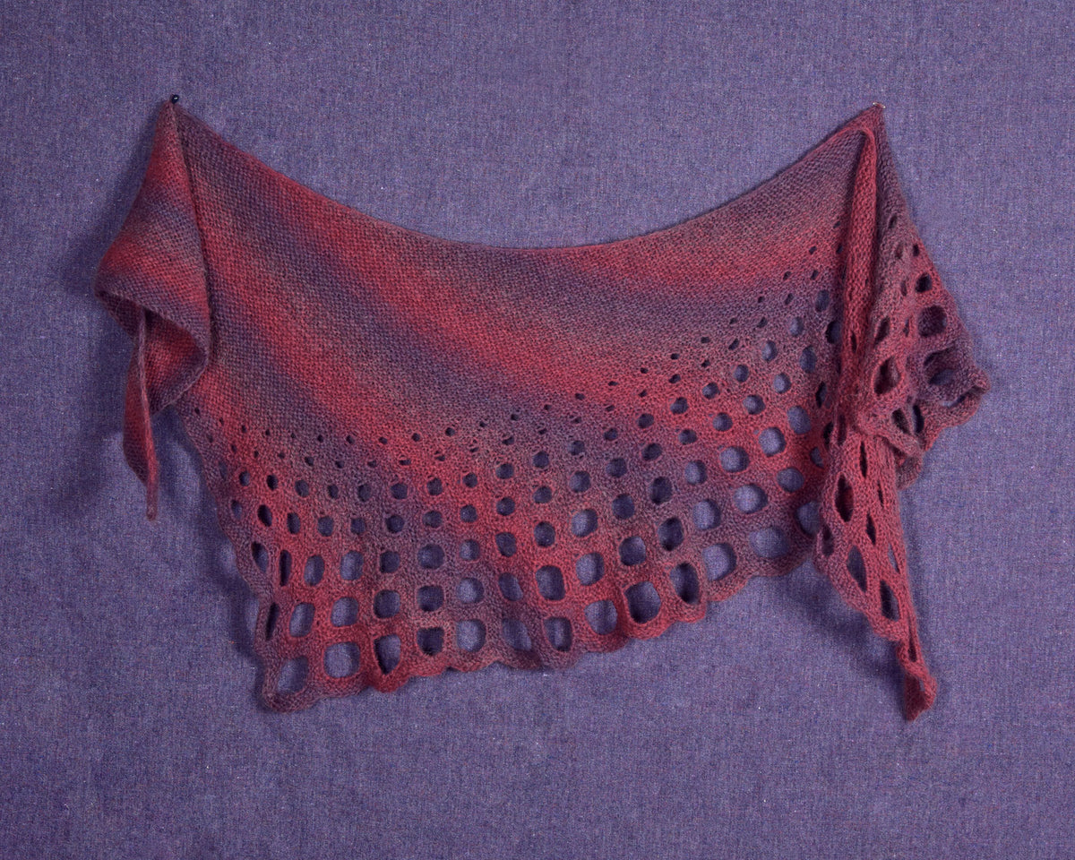 Trypophobia Shawl in red and purple laid flat