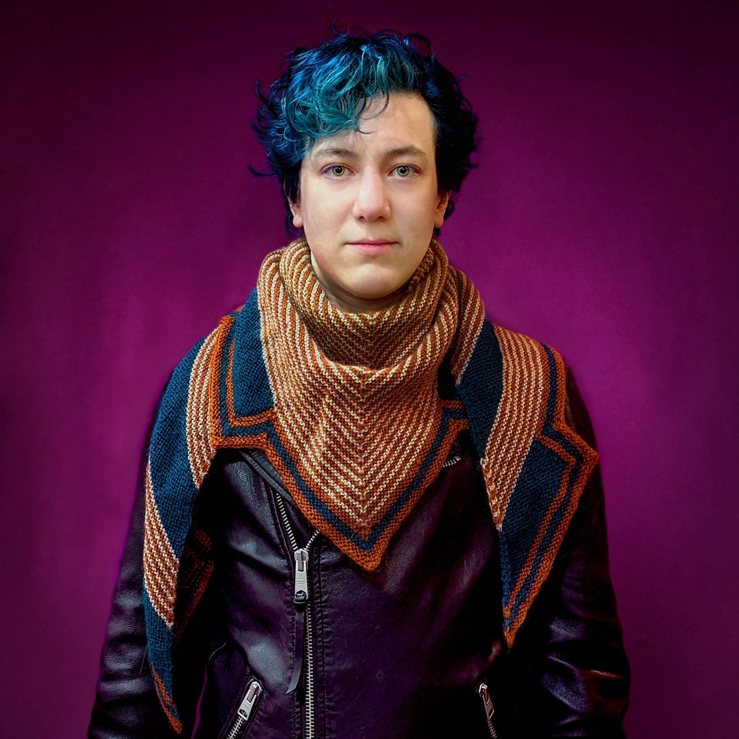 Xandy Peters, knitting designer, wearing a striped knitted shawl
